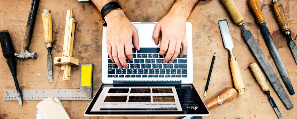 man on laptop on the table with tools